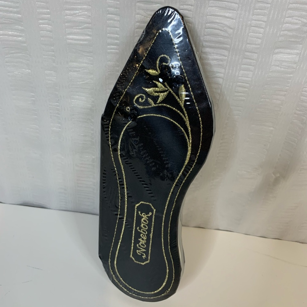 Marks & Spencer unique notebook black shoe shaped with gold trim.